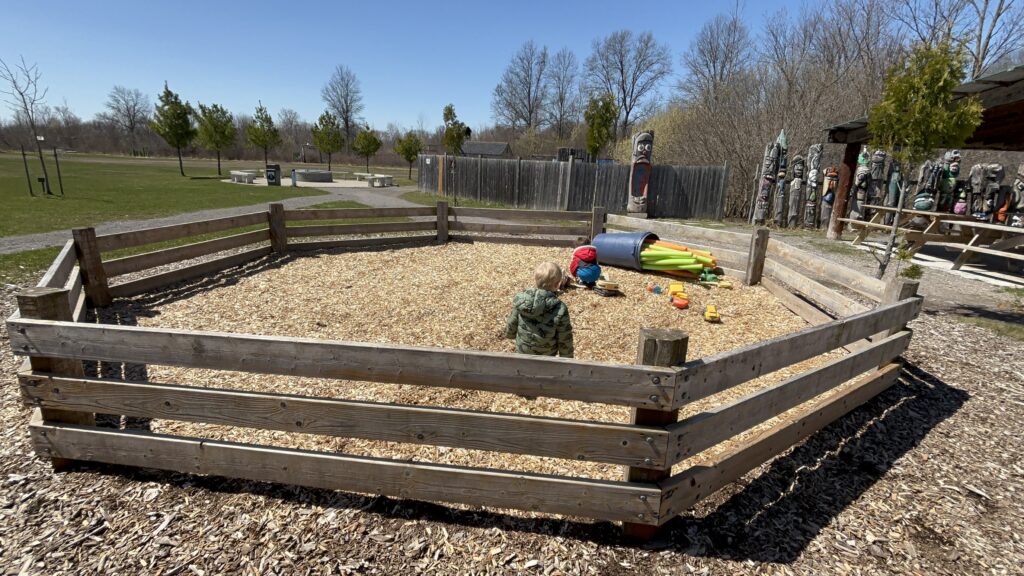 Kids playing in the Heartland Forest fenced play pen